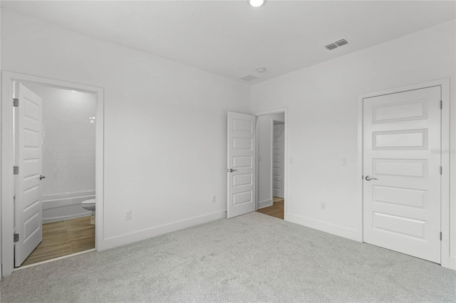 13081 Sunrise Harvest Dr, Winter Garden, FL 34787 - unfurnished bedroom featuring carpet, baseboards, and connected bathroom