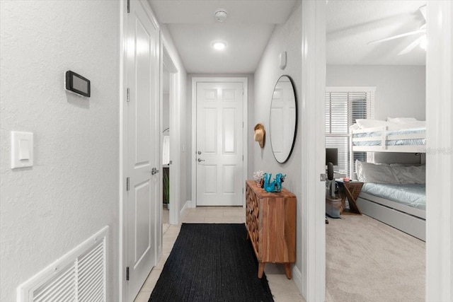 1 Riverwalk Dr Unit 303, New Smyrna Beach, FL 32169 - corridor featuring a textured wall, light tile patterned floors, baseboards, and recessed lighting