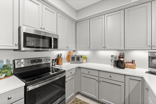 1 Riverwalk Dr Unit 303, New Smyrna Beach, FL 32169 - kitchen featuring stainless steel appliances, gray cabinets, and light countertops
