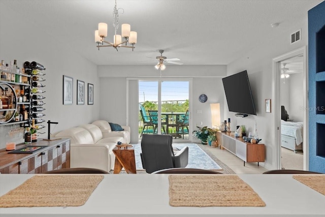 1 Riverwalk Dr Unit 303, New Smyrna Beach, FL 32169 - living room with a ceiling fan and a chandelier