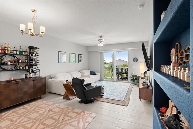 1 Riverwalk Dr Unit 303, New Smyrna Beach, FL 32169 - living room with ceiling fan, a chandelier, and a textured ceiling