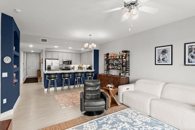 1 Riverwalk Dr Unit 303, New Smyrna Beach, FL 32169 - living room featuring a chandelier, recessed lighting, a ceiling fan, and baseboards