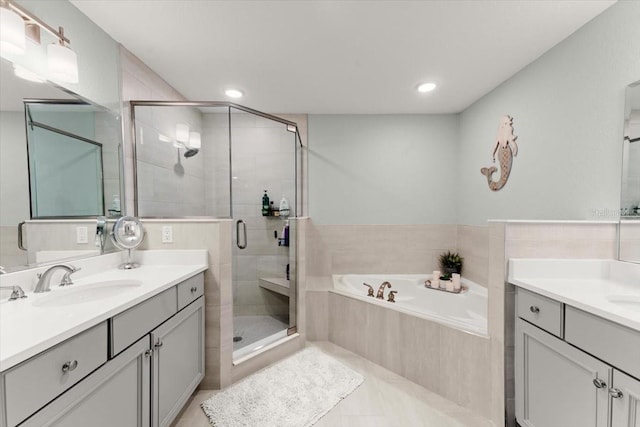 1 Riverwalk Dr Unit 303, New Smyrna Beach, FL 32169 - bathroom with a stall shower, a bath, two vanities, tile patterned floors, and recessed lighting