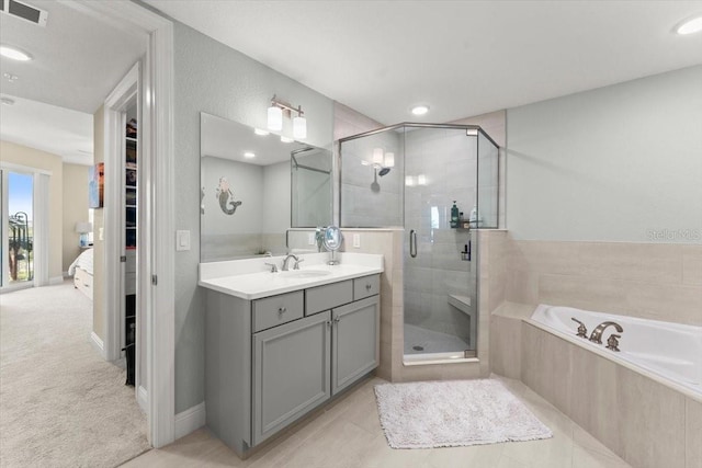 1 Riverwalk Dr Unit 303, New Smyrna Beach, FL 32169 - full bath with a shower stall, vanity, a garden tub, and recessed lighting