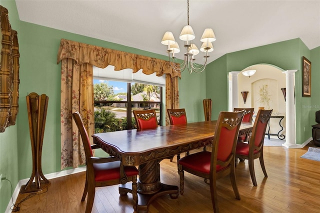 4571 Abaco Dr, Tavares, FL 32778 - dining room with a chandelier, decorative columns, baseboards, and light wood-type flooring