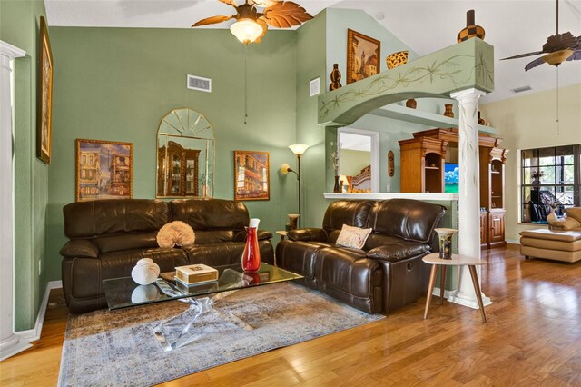 4571 Abaco Dr, Tavares, FL 32778 - living area featuring a ceiling fan, high vaulted ceiling, decorative columns, wood finished floors, and baseboards