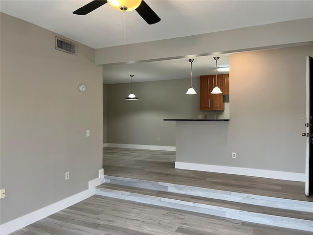 155 N Pearl Lake Cswy Unit 104, Altamonte Springs, FL 32714 - unfurnished living room with a ceiling fan, baseboards, and wood finished floors