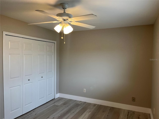 155 N Pearl Lake Cswy Unit 104, Altamonte Springs, FL 32714 - unfurnished bedroom featuring a closet, wood finished floors, baseboards, and ceiling fan