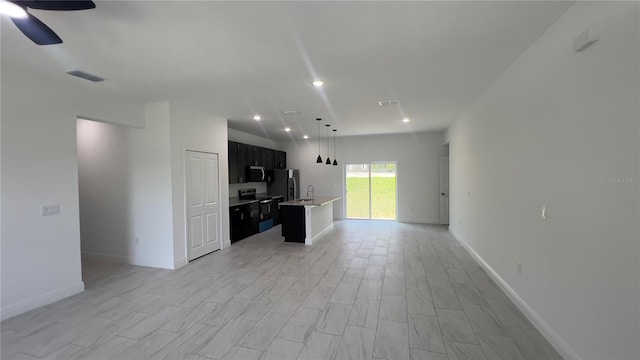 3315 W Montgomery Ln, Citrus Springs, FL 34433 - kitchen featuring open floor plan, appliances with stainless steel finishes, light countertops, recessed lighting, and a sink