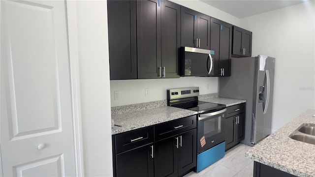 3315 W Montgomery Ln, Citrus Springs, FL 34433 - kitchen with stainless steel appliances, dark cabinets, light marble finish flooring, and a sink