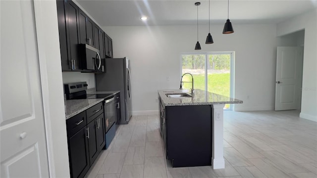 3315 W Montgomery Ln, Citrus Springs, FL 34433 - kitchen featuring appliances with stainless steel finishes, a sink, a center island with sink, dark cabinets, and recessed lighting