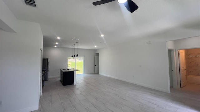 3315 W Montgomery Ln, Citrus Springs, FL 34433 - unfurnished living room featuring ceiling fan, a sink, recessed lighting, and baseboards