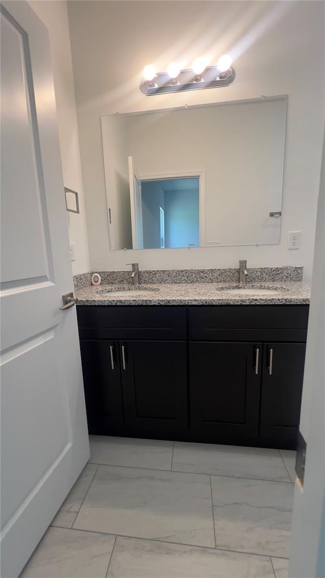 3315 W Montgomery Ln, Citrus Springs, FL 34433 - bathroom featuring marble look tile flooring and double vanity