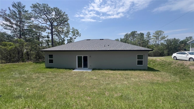 3315 W Montgomery Ln, Citrus Springs, FL 34433 - back of property featuring stucco siding, a yard, and a shingled roof