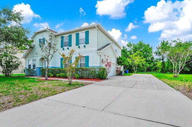309 Black Springs Ln, Winter Garden, FL 34787 - view of front of house featuring driveway, stucco siding, and a front lawn