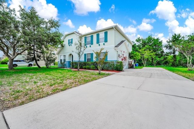 309 Black Springs Ln, Winter Garden, FL 34787 - traditional home featuring driveway, a front lawn, and stucco siding