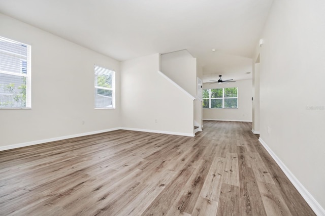 309 Black Springs Ln, Winter Garden, FL 34787 - unfurnished living room featuring light wood-type flooring, stairs, a ceiling fan, and baseboards