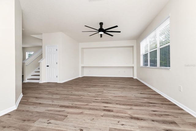 309 Black Springs Ln, Winter Garden, FL 34787 - spare room with wood finished floors, a ceiling fan, baseboards, and stairway