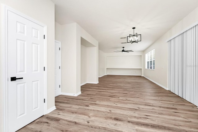 309 Black Springs Ln, Winter Garden, FL 34787 - unfurnished dining area with a chandelier, light wood-style flooring, baseboards, and a ceiling fan