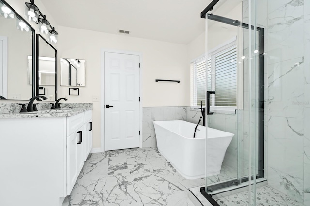 309 Black Springs Ln, Winter Garden, FL 34787 - full bath with marble finish flooring, a marble finish shower, vanity, a freestanding bath, and tile walls