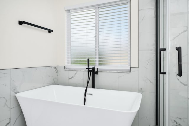 309 Black Springs Ln, Winter Garden, FL 34787 - full bathroom with tile walls, a freestanding bath, and a marble finish shower