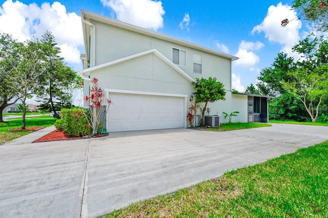 309 Black Springs Ln, Winter Garden, FL 34787 - view of front facade with concrete driveway, stucco siding, central AC, and a garage