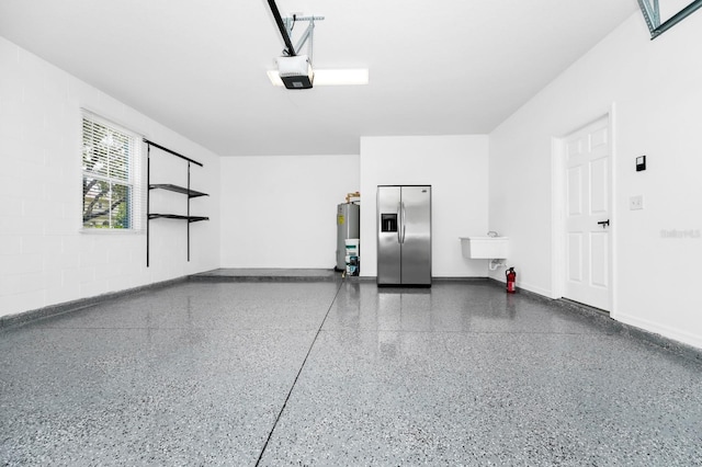 309 Black Springs Ln, Winter Garden, FL 34787 - garage featuring stainless steel fridge with ice dispenser, water heater, a garage door opener, and baseboards