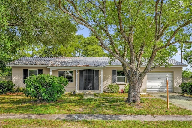 2357 E Dana Dr, Deltona, FL 32738 - ranch-style house featuring a garage, metal roof, concrete driveway, and stucco siding