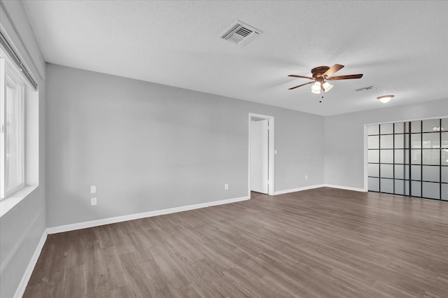 2357 E Dana Dr, Deltona, FL 32738 - unfurnished room with a ceiling fan, wood finished floors, baseboards, and a textured ceiling