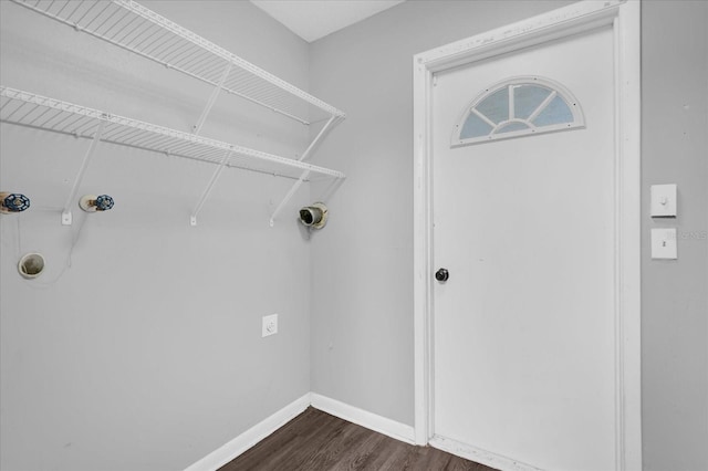 2357 E Dana Dr, Deltona, FL 32738 - laundry area with dark wood-style floors and baseboards