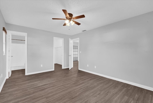 2357 E Dana Dr, Deltona, FL 32738 - unfurnished bedroom with baseboards, dark wood finished floors, a spacious closet, and ceiling fan