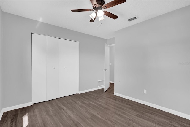 2357 E Dana Dr, Deltona, FL 32738 - unfurnished bedroom with wood finished floors, baseboards, a closet, and a ceiling fan