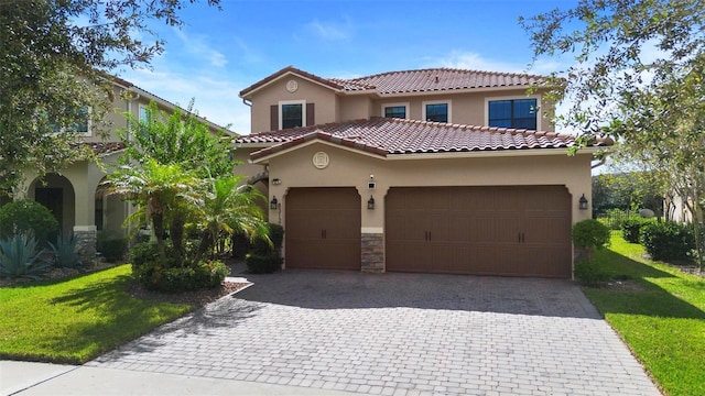 8312 Prestbury Dr, Orlando, FL 32832 - mediterranean / spanish-style home with stucco siding, decorative driveway, and an attached garage