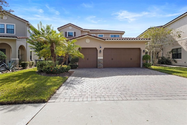 8312 Prestbury Dr, Orlando, FL 32832 - mediterranean / spanish home with decorative driveway, stucco siding, stone siding, a garage, and a tiled roof