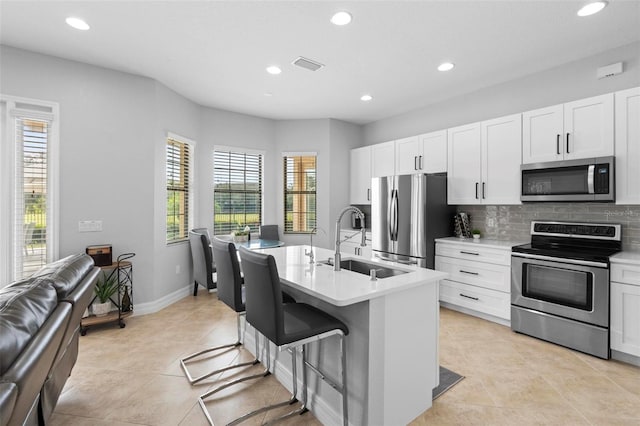 8312 Prestbury Dr, Orlando, FL 32832 - kitchen featuring stainless steel appliances, a sink, plenty of natural light, recessed lighting, and tasteful backsplash