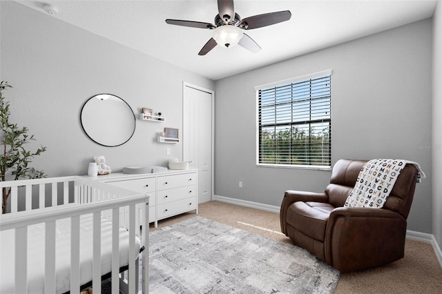 8312 Prestbury Dr, Orlando, FL 32832 - bedroom with light carpet, a crib, baseboards, and a ceiling fan