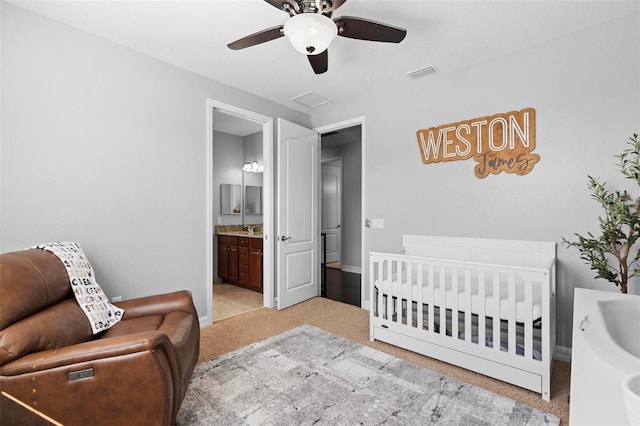 8312 Prestbury Dr, Orlando, FL 32832 - bedroom with light carpet, baseboards, a sink, ceiling fan, and ensuite bath