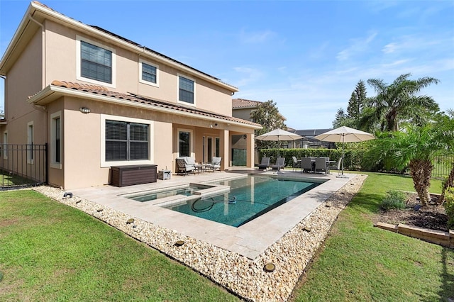 8312 Prestbury Dr, Orlando, FL 32832 - back of house with a patio area, stucco siding, a pool with connected hot tub, and a tiled roof