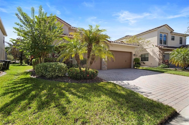 8312 Prestbury Dr, Orlando, FL 32832 - mediterranean / spanish home featuring a garage, decorative driveway, stucco siding, a front lawn, and stone siding