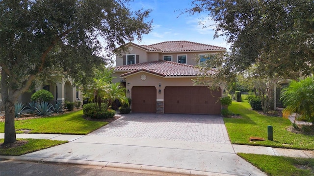 8312 Prestbury Dr, Orlando, FL 32832 - mediterranean / spanish-style house featuring stucco siding, decorative driveway, a front yard, and a tile roof