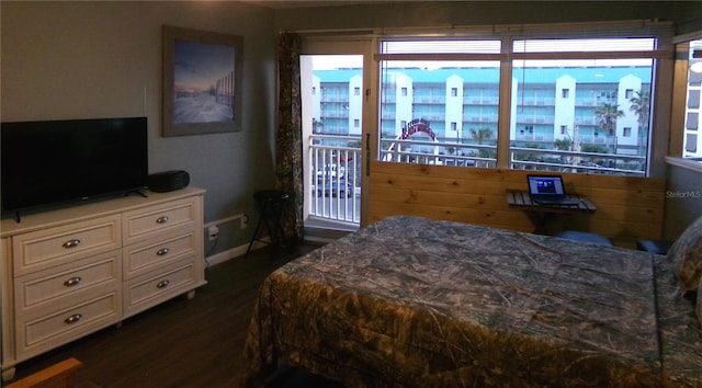 219 S Atlantic Ave Unit 436, Daytona Beach, FL 32118 - bedroom with dark wood-type flooring, access to exterior, and baseboards