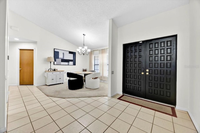 2900 Hammock Dr, Plant City, FL 33566 - entryway featuring a chandelier, lofted ceiling, light tile patterned floors, and a textured ceiling