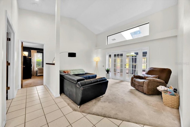 2900 Hammock Dr, Plant City, FL 33566 - living area with light colored carpet, high vaulted ceiling, french doors, light tile patterned floors, and a skylight
