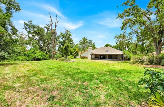 2900 Hammock Dr, Plant City, FL 33566 - view of green lawn with a sunroom