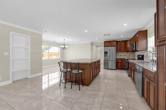 181 W Minnehaha Ave, Clermont, FL 34711 - kitchen featuring appliances with stainless steel finishes, a chandelier, a center island, crown molding, and a sink