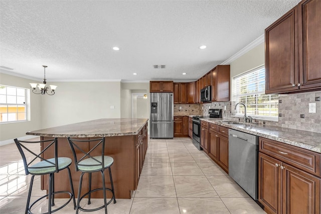 181 W Minnehaha Ave, Clermont, FL 34711 - kitchen featuring appliances with stainless steel finishes, a sink, decorative backsplash, a breakfast bar, and a chandelier