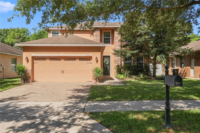 2762 Pepper Ln, Orlando, FL 32812 - view of front facade featuring driveway, stucco siding, a garage, and a front lawn