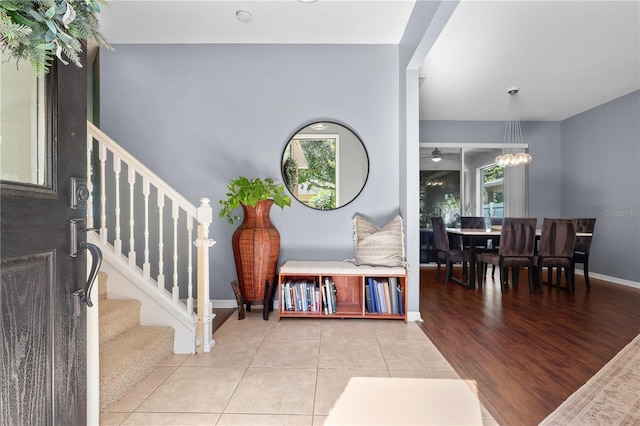 2762 Pepper Ln, Orlando, FL 32812 - foyer featuring stairs, tile patterned floors, baseboards, and a ceiling fan