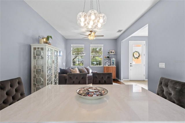 2762 Pepper Ln, Orlando, FL 32812 - dining space with a chandelier, a ceiling fan, and baseboards