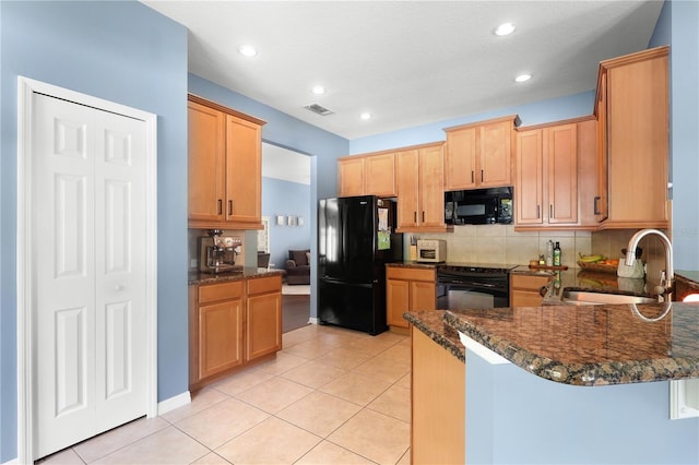 2762 Pepper Ln, Orlando, FL 32812 - kitchen featuring black appliances, a sink, decorative backsplash, a peninsula, and light tile patterned floors